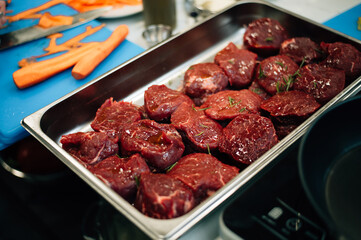 raw filet mignon sprinkled with garlic and seasonings