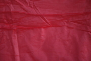 Crimson Fabric Texture: A captivating view of richly textured crimson fabric, showcasing subtle...