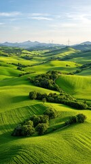 Obraz premium Aerial View of Lush Green Rolling Hills Under a Sunny Sky