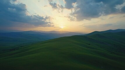 Fototapeta premium Rolling Green Hills at Sunset with Cloudy Sky Scenic Landscape