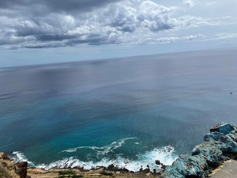 Oahu Hawaii coastline with ocean waves hitting the rocks, top or aerial view