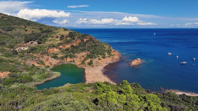 Aerial view of Terranera lake, a pond with emerald green water of sulfur origin between the village of Porto Azzurro and  on Elba Island, Tuscany, Italy
