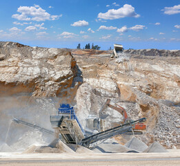 Stone crushing machine at open pit mining, processing plant for crushed stone. Piles of gravel stone and conveyor belts. Excavator and truck loading rocks. Concepts of industry and building materials