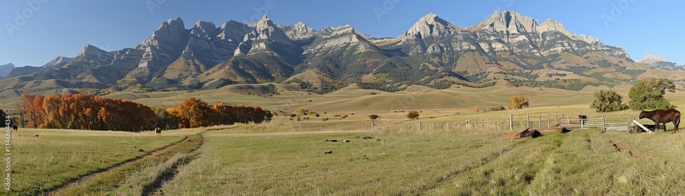 Poster a beautiful mountain range with a large field in between