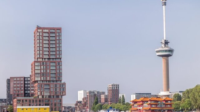Rotterdam cityscape timelapse with Euromast observation tower and a tourist boat on Nieuwe Maas River. Waterfront features modern skyscrapers, a floating Chinese restaurant and a scenic harbor view