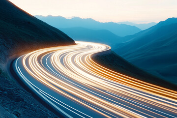 Long exposure shot of car lights creating a motion blur on a winding mountain road at dusk, with blue mountains in the background