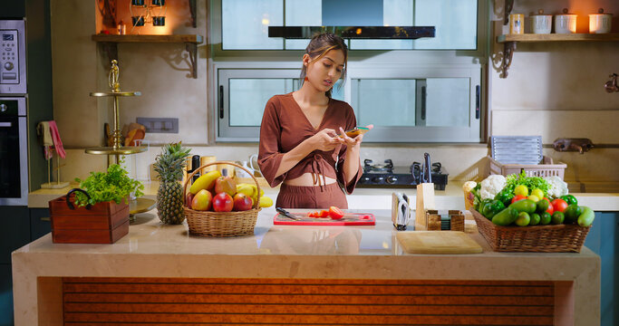 Indian happy young adult gen z woman lady hold mobile typing text sms app indoor home relax teen age female girl use phone look screen chat online watch funny video have fun joy enjoy day spend time	 - Powered by Adobe