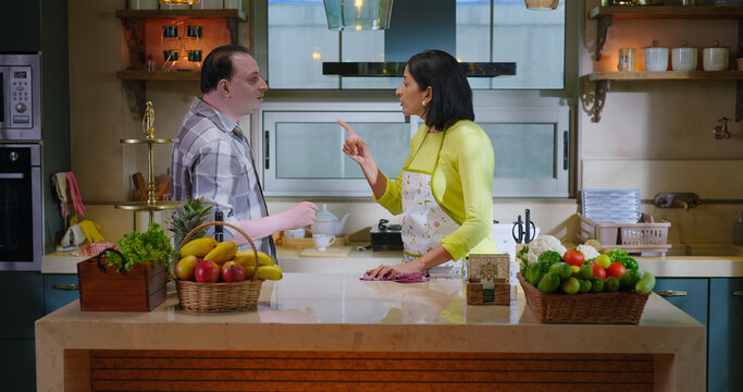 Indian upset middle aged adult gen x couple pair male female do bad fight argue indoor modern kitchen home. older angry husband man abuse insult each other shout on lady wife at house	 - Powered by Adobe