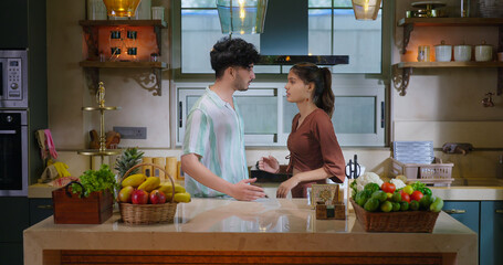 Indian upset tense teen age girl boy male female guy couple standing indoor kitchen talk lies do insult angry sad stress young adult gen z man woman speak argue on family issue feel bad day home place