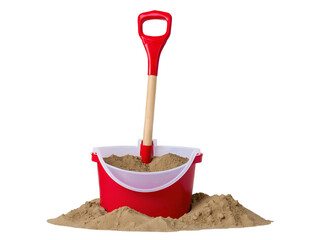 Red bucket with sand and plastic shovel for sandcastle construction