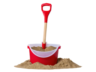 Red bucket with sand and plastic shovel for sandcastle construction