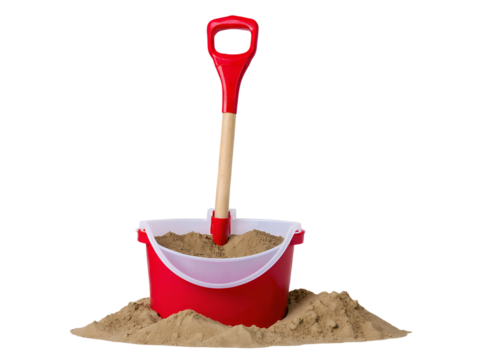 Red bucket with sand and plastic shovel for sandcastle construction