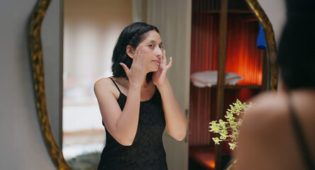 Indian gen x senior mature adult older elder short hair woman lady look mirror use beauty apply...