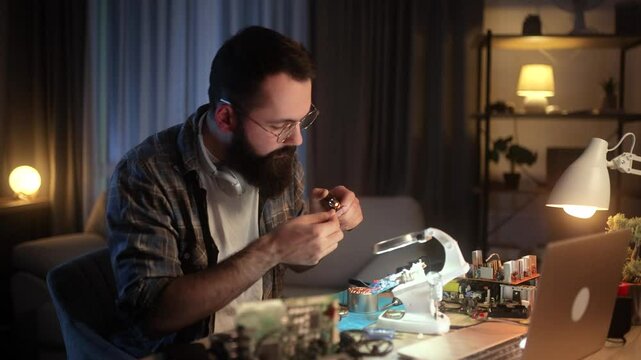 Man using heat shrink tubing to insulate wires in an electronics repair project