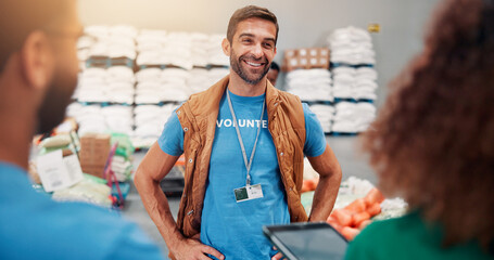 Helping, charity and people with tablet, smile and review of donations on website or discussion. Social responsibility, volunteers and group in warehouse with coordinator for community service or NGO