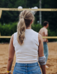 Beach volleyball game, team of adult friends athletes play volleyball by the sea, players on the...