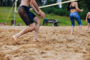 Beach volleyball game, team of adult friends athletes play volleyball by the sea, players on the...