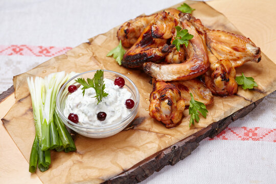 chicken wings with sauce on the wooden background