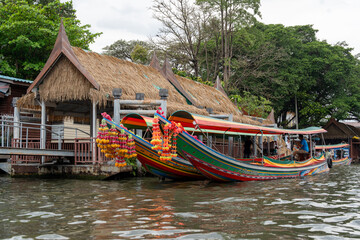 A khlong or river channel of Chao Phraya river with longtail wooden boats and residential buildings in Bangkok Thailand Asia 