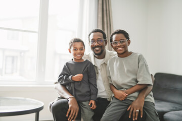 Father and two sons having great time on the livingroom