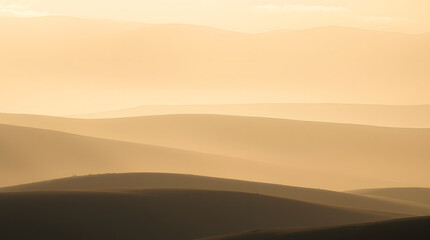 Obraz premium A serene landscape at sunset with gentle hills and a warm, glowing horizon.