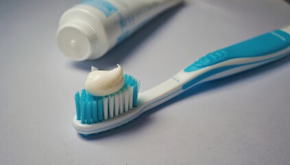 Toothbrush with toothpaste on white background