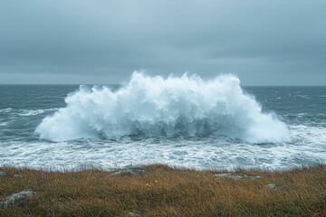 Powerful ocean wave crashes against coast, dramatic scene.
