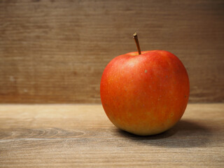 Red apple on a wooden kitchen counter