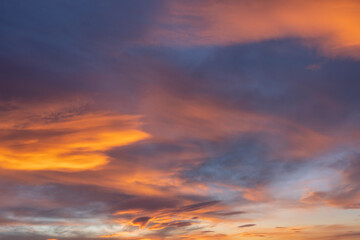 Glowing real sky at sunset texture background overlay. Dramatic red and orange clouds.