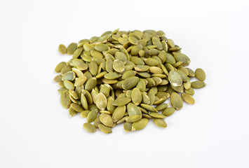 Pile of green pumpkin seeds on a white background