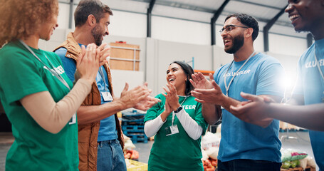 Volunteer teamwork, people or happy with applause in community center for outreach success or donation target. NGO charity, social responsibility or group with food bank achievement or campaign goals