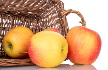 Several juicy apples in a basket, macro, isolated on a white background.