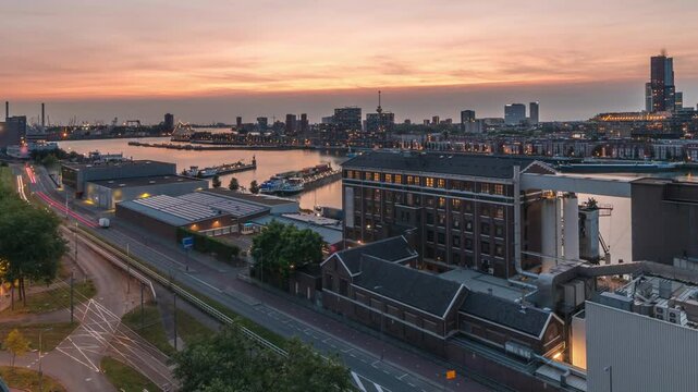Aerial panoramic view over Maashaven day to night transition timelapse with moored ships, Katendrecht and Maas River in Rotterdam. Traffic near former factory converted into office and event space