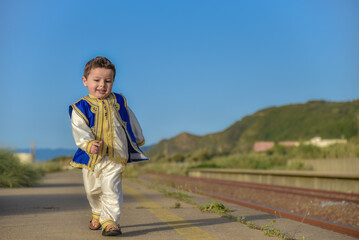 Eid clothes, Happy Muslim child in traditional dress on Eid day, A little boy playing and having...