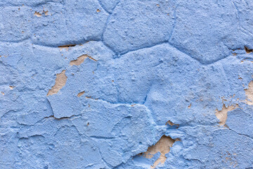 Blue wall with cracked paint texture background, wall surface peeling off. Cracked surface of aged blue wall perfect for creative design. Concept of cracked vintage background for stylish decor