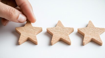 Hand placing wooden star symbolizing customer feedback and user rating concept