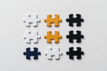 Obraz premium Colorful puzzle pieces arranged in grid pattern on plain surface