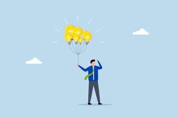 Innovation idea, smart businessman holding lightbulb idea balloons.
