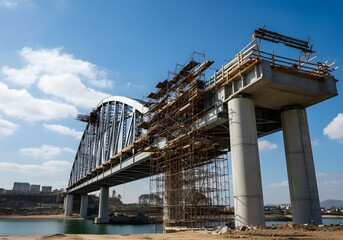 A large steel bridge under construction with scaffolding.