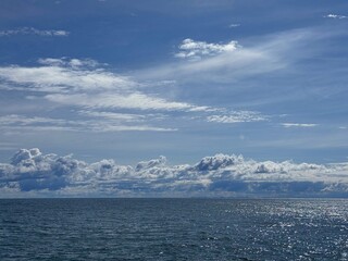 Beautiful shiny ocean and scenic  sky clouds