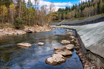 Southern Urals, a rapids on the mountain river Aigir. The reinforced river shore at the railway station.