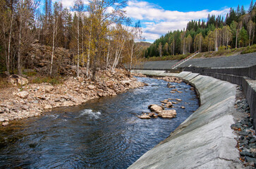 Southern Urals, a rapids on the mountain river Aigir. The reinforced river shore at the railway station.