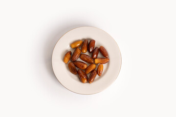 dates palm fruit on plate isolated on white background.