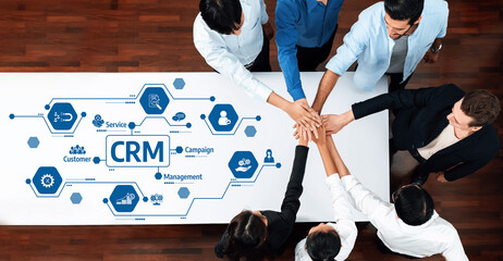 A diverse team collaborates around a table, engaging in a Customer Relationship Management strategy, emphasizing teamwork and innovative business solutions for effective growth. Amity