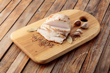 Salted lard with spices on a cutting board.