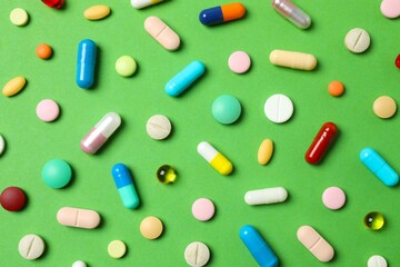 Various pills on color background, top view