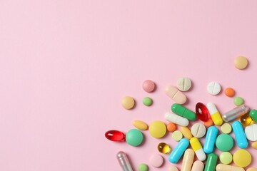 Various pills on color background, top view