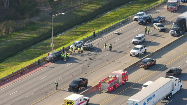 Traffic accident on American highway in Kentucky. First responders helping victims of car crash on freeway road in USA. Emergency services responding to accident site