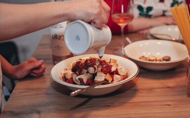 the process of making italian salad with vegetables