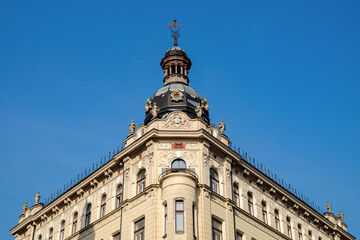 Fototapeta premium Eclectic style historic building in Riga, Latvia, featuring a Baroque dome, Renaissance details, and an ornate facade on Krishjana Barona street 15, Rīga.